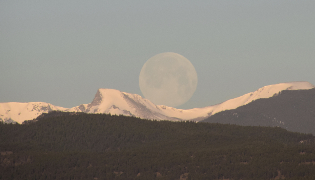 Pink Moon sets behind Elk Tooth